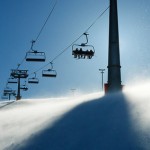 backlit scenes with ski lift chairs